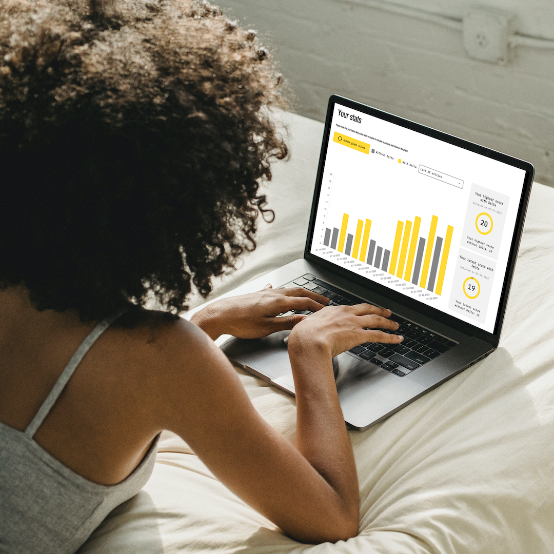 Woman checking her DELTA BrainLuxury Test Your Optimum score report