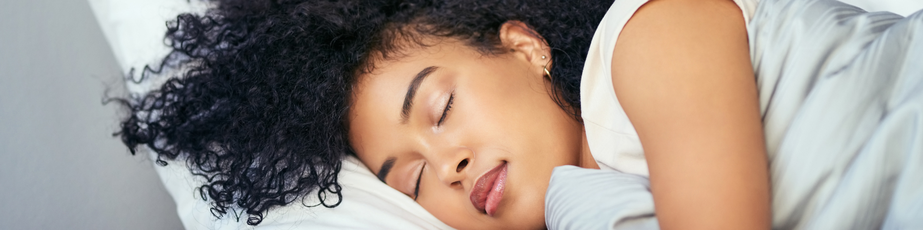Woman sleeps peacefully in her bed 