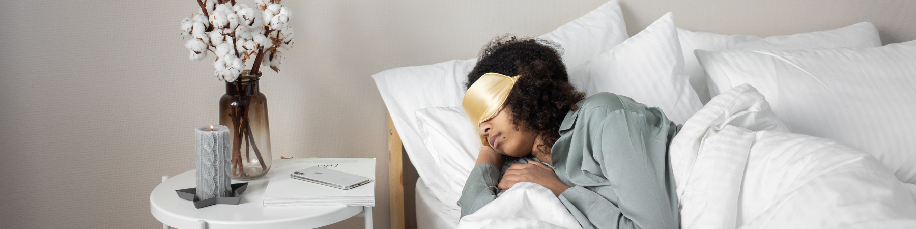 A woman sleeping in bed with eye mask on